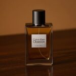 ck obsession for men bottle on dark background with amber lighting